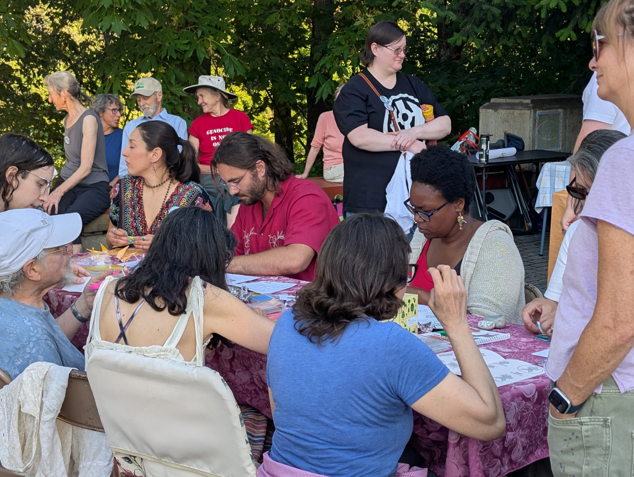Briae Lewis surrounded by community members folding origami